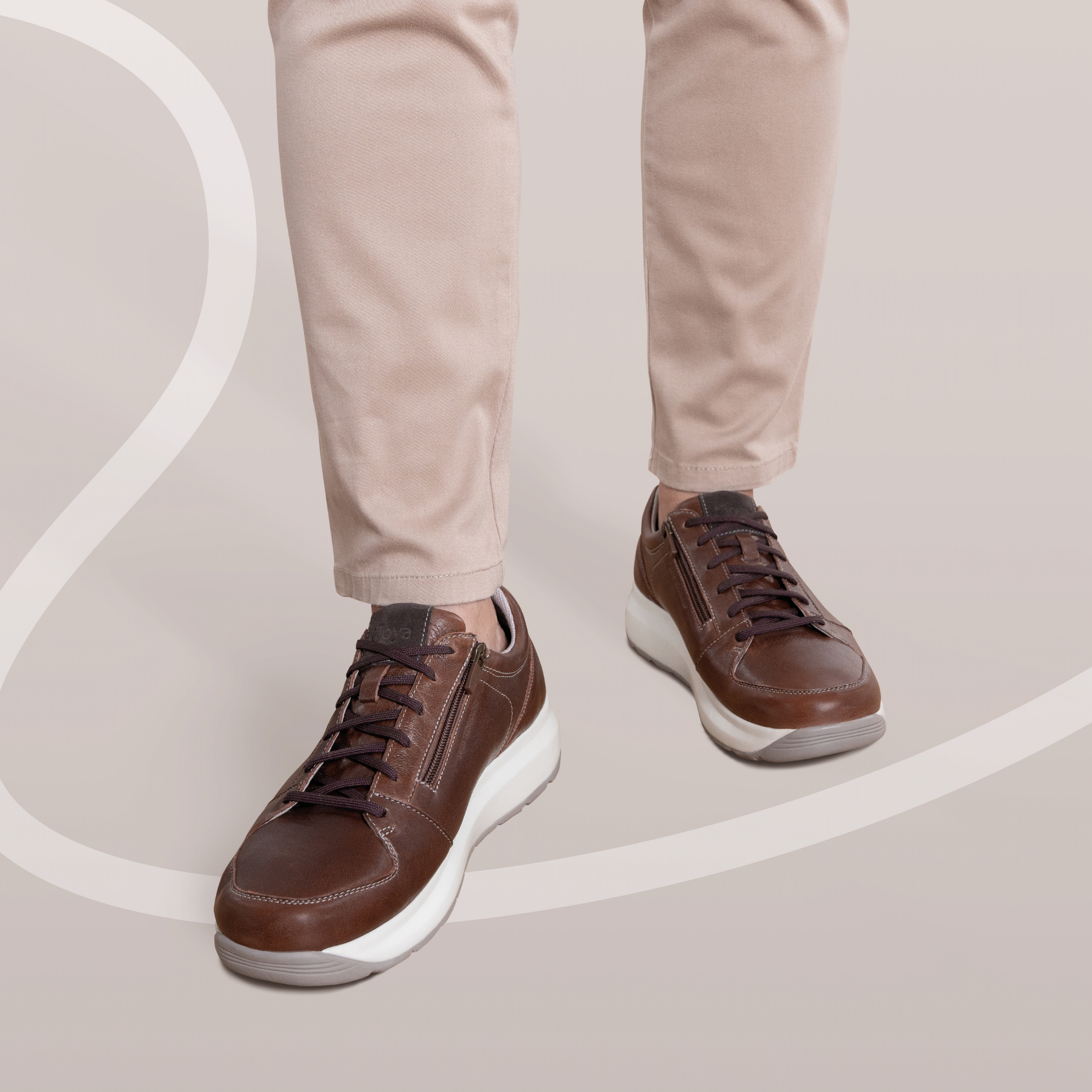 close up of brown shoes on a man beige background