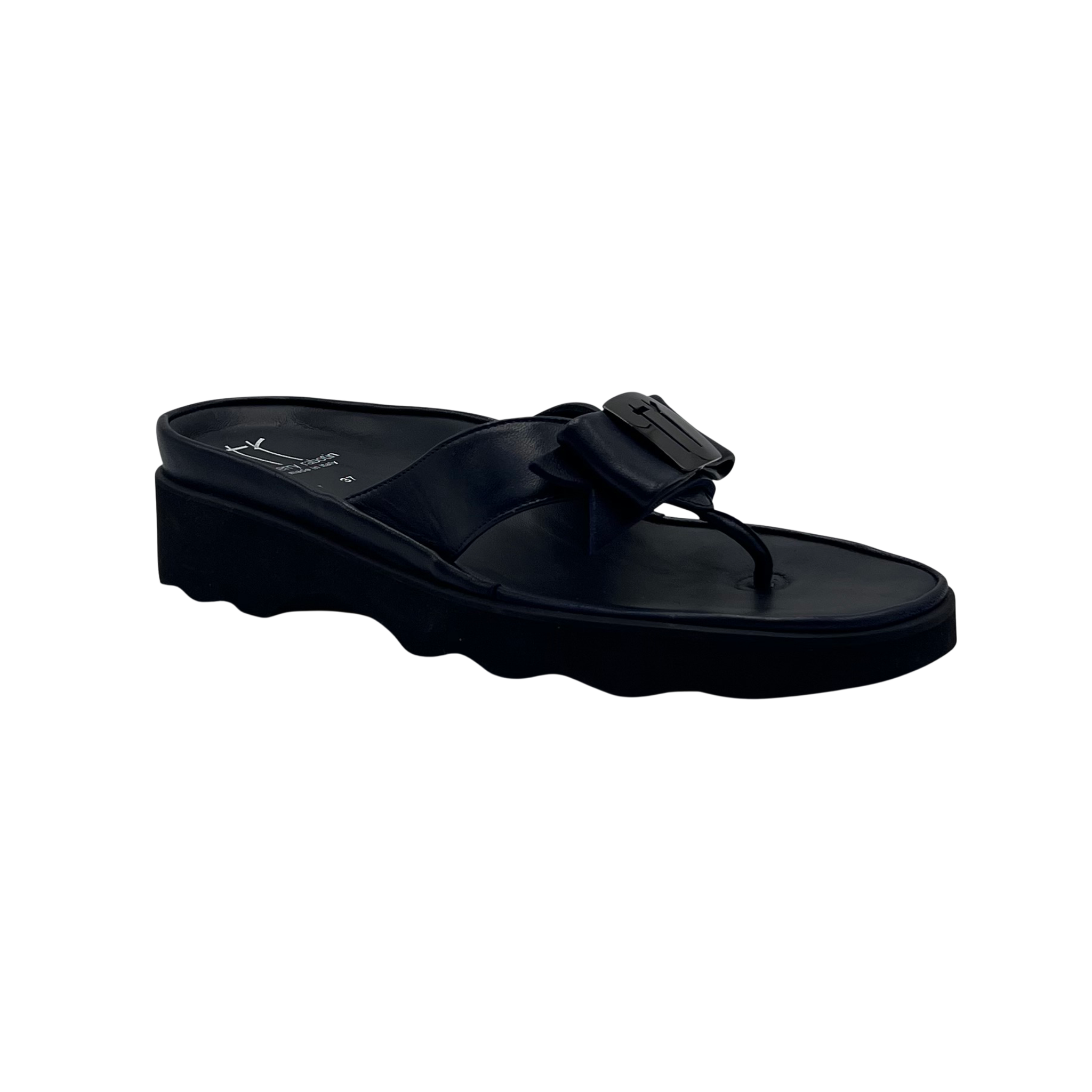 A single black platform thong sandal with a wide strap and a decorative buckle detail, shown from a side profile on a plain white background.