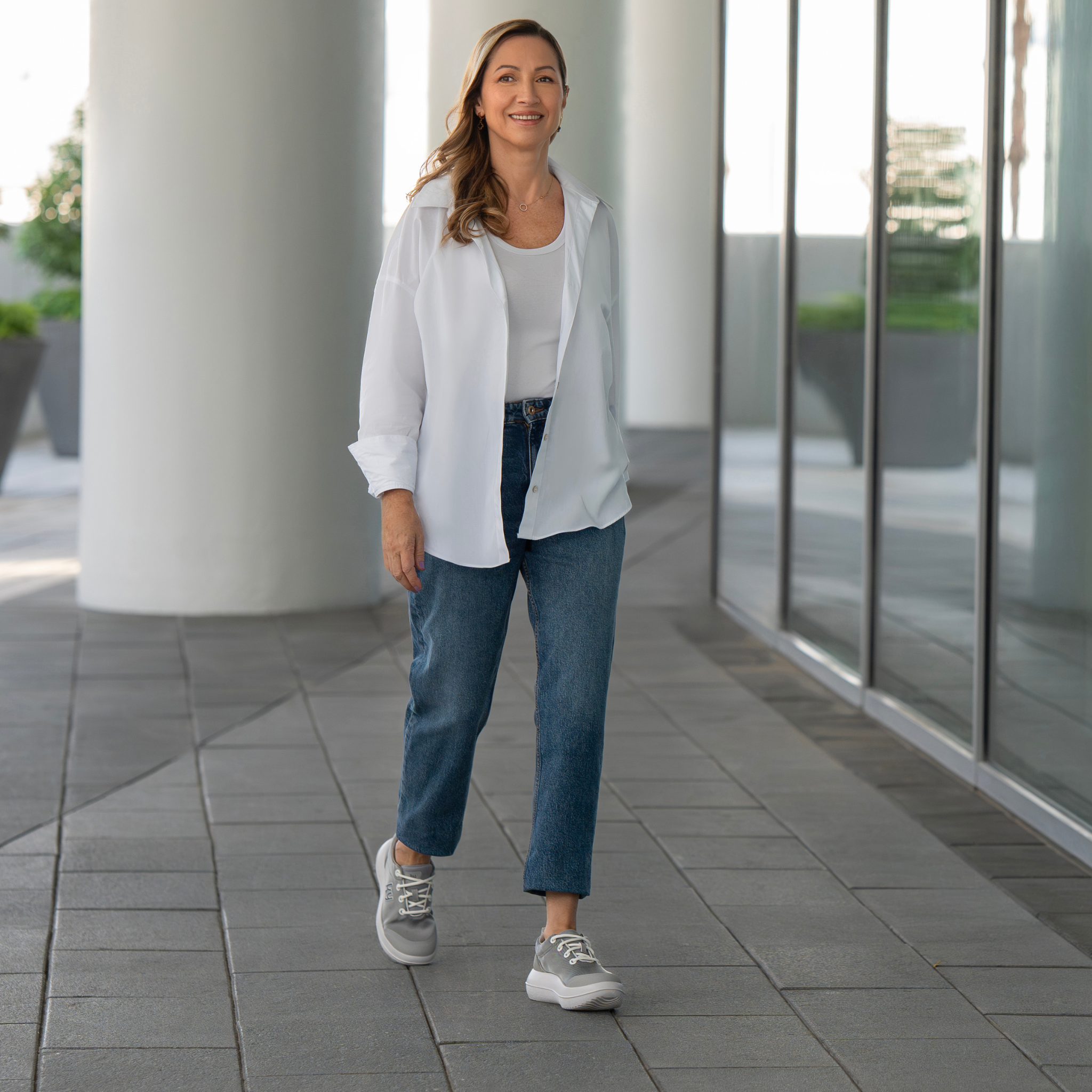 women walking wearing sliver sneakers