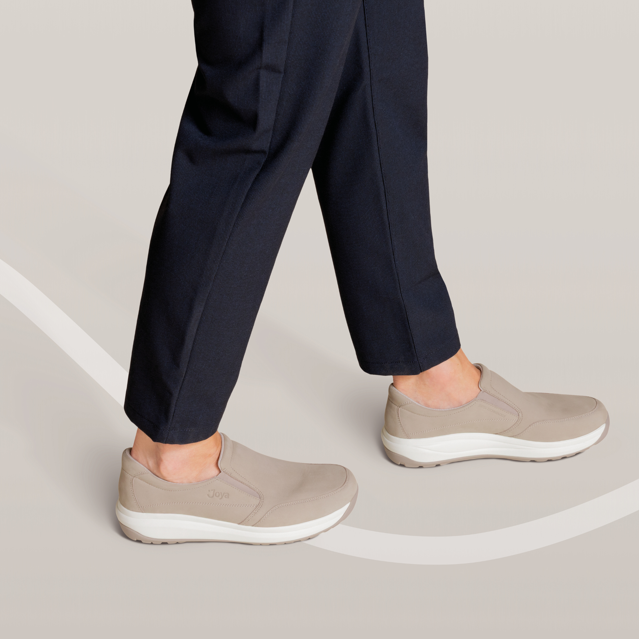 lifestyle image of person wearing Joya Men's Traveler II Beige Shoe on grey background