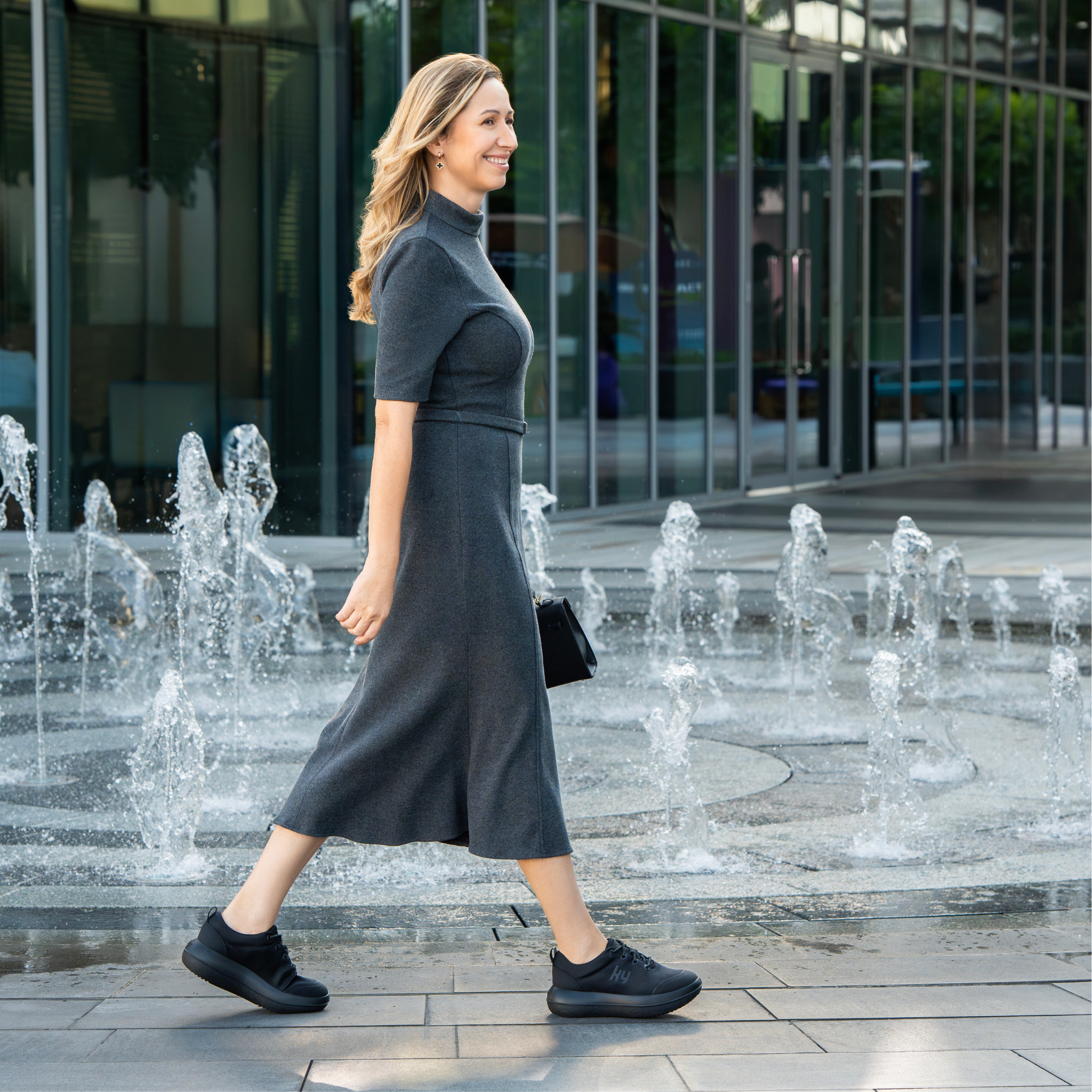 women in front of modern building wearing black kybun sneakers