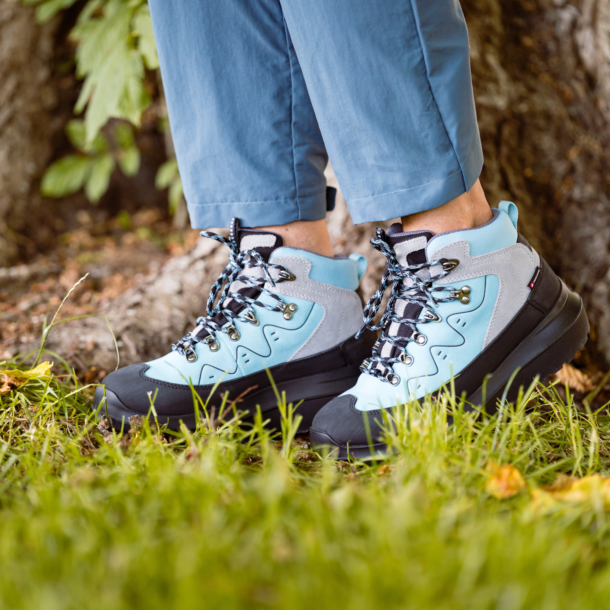 women wearing aqua boots standing on grass