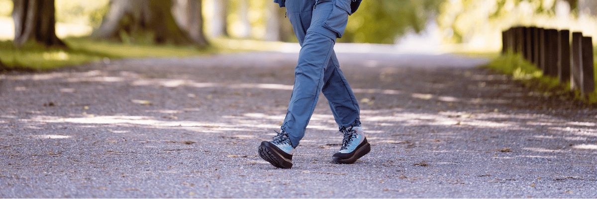 women walking in park wearing jeans and blue boots