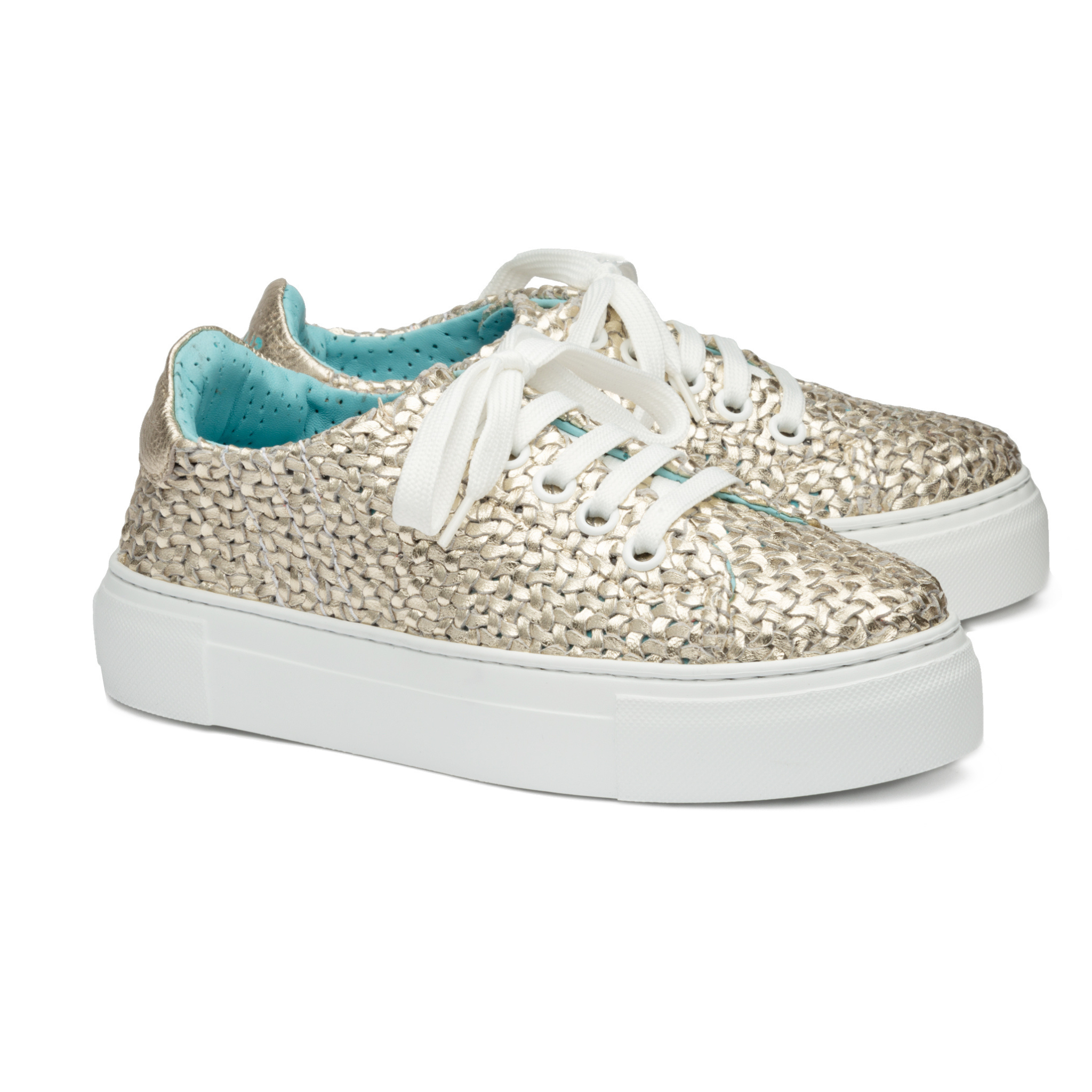 Silver glitter sneakers with white laces on a white background