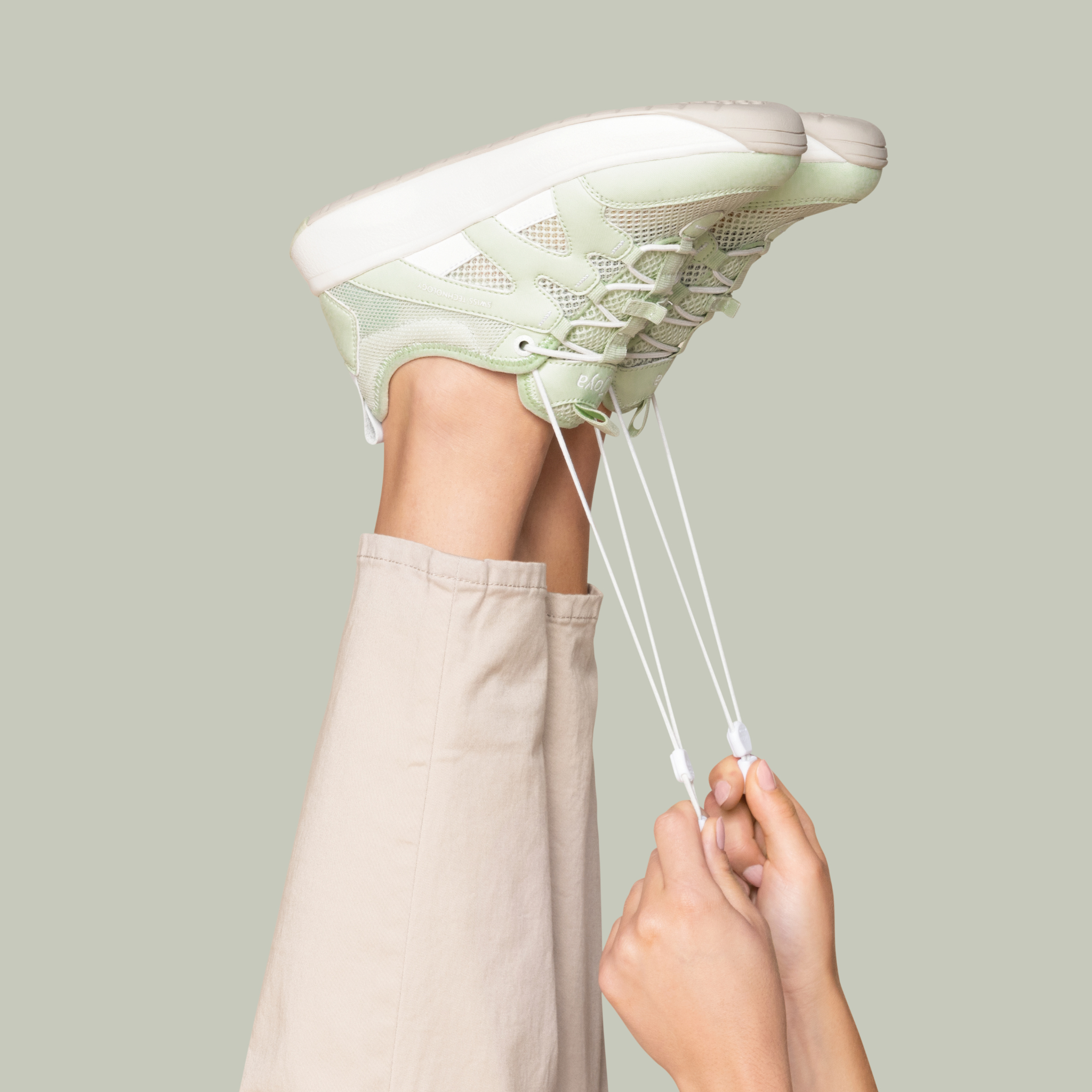 women wearing green sneakers on green background