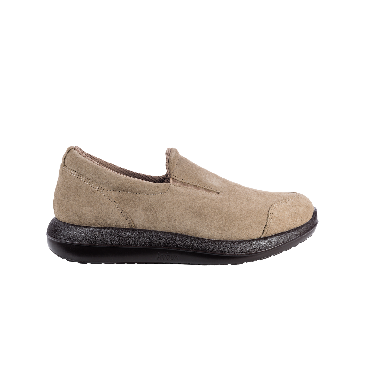 A single slip-on shoe in light beige suede with a black sole, shown in a side profile view against a plain white background.