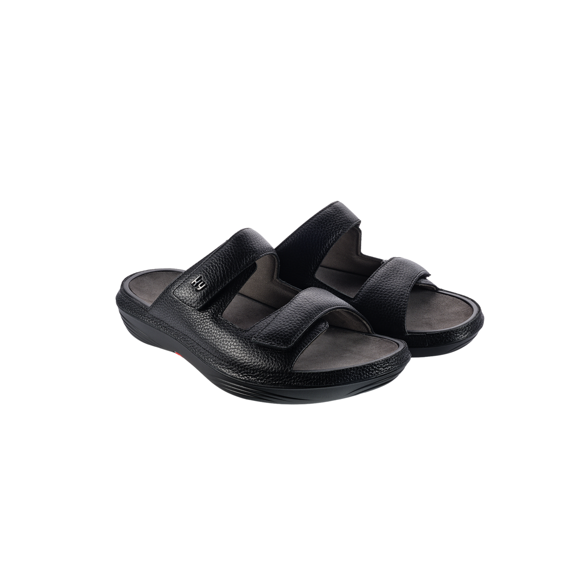 A pair of black leather slide sandals with wide adjustable straps and a contoured sole, shown on a plain white background.