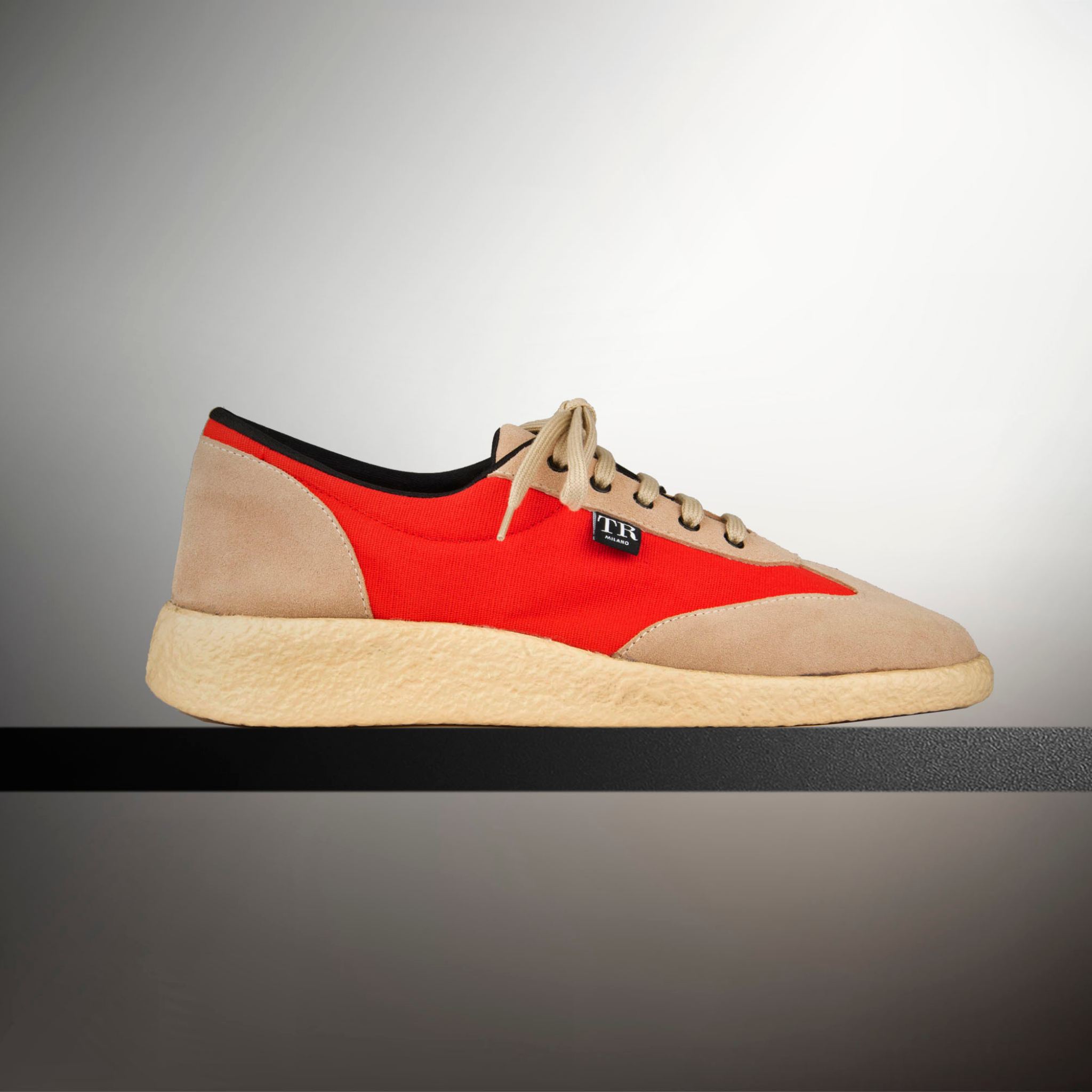 beige and orange flat shoe on black  and white background